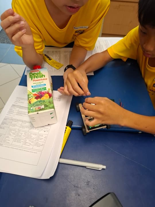 Students building Solar Bus with Recycled Juice Carton.
