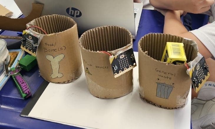 Three smart bins, each coded to know what goes inside. A primary school waste-sorting prototype.