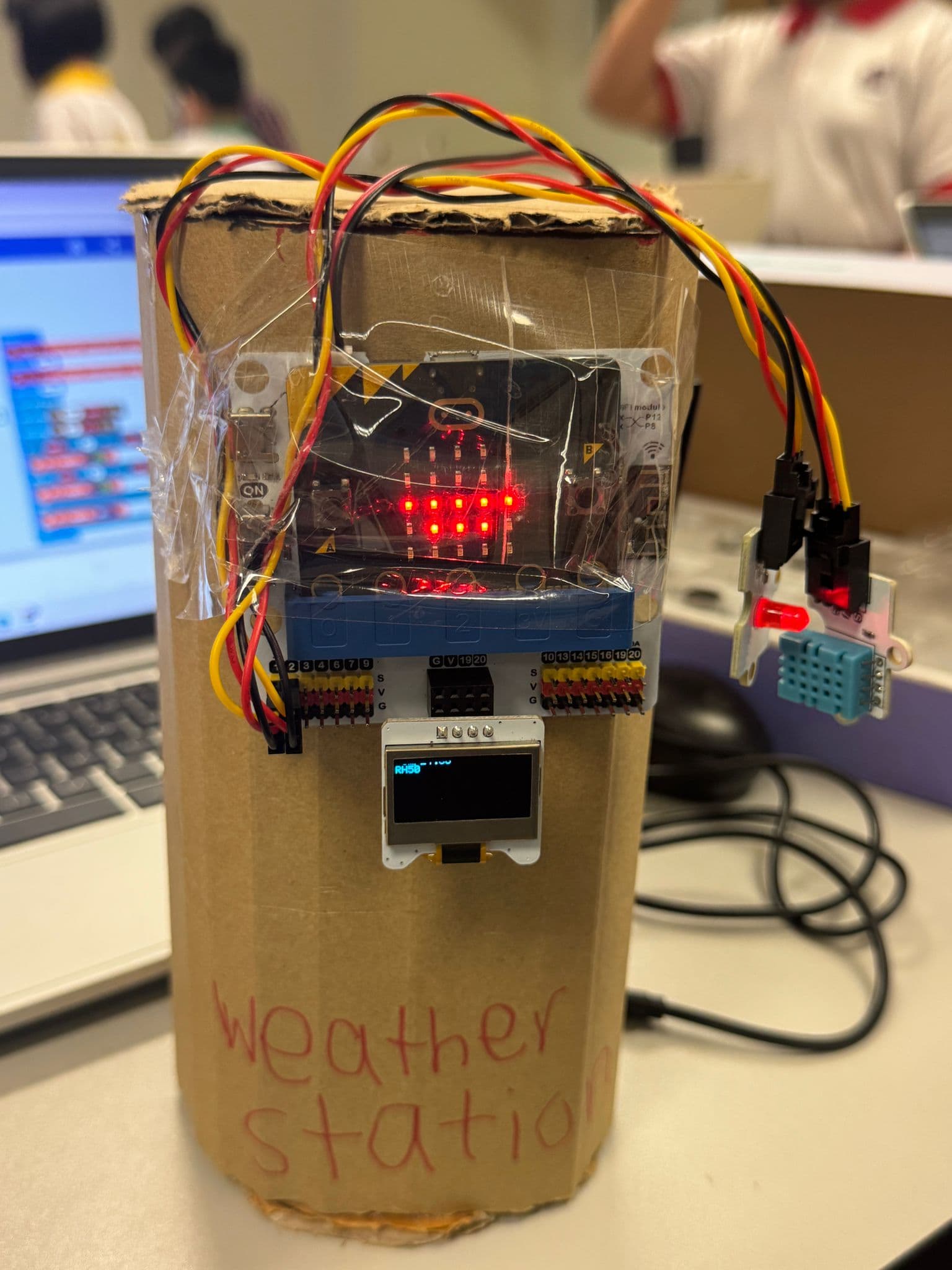 A working weather station with live temperature and humidity readings — wired and coded by a primary school student.